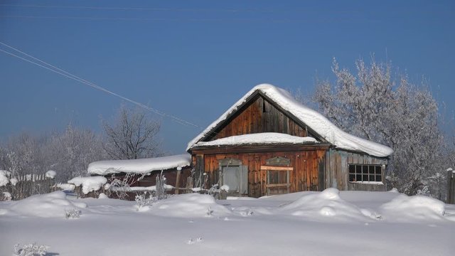 Traditional russian country house izba in village Talitsa under winter snow. Altai, Siberia, Russia
