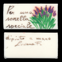 An isolated handmade Italian soap with flowers against a black background (translation from the Italian: 