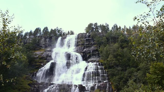 Three views of waterfall Tvindefossen in sunny summer day, Norway full view, cropped and closeup