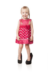Smiling little girl wearing big shoes