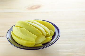 Preserved mango fruits in black bowl