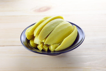 Preserved mango fruits in black bowl