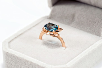 Gold ring with blue Topaz in a velvet gift box