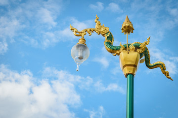 Fototapeta na wymiar king of snake lamppost with cloud sky in Thailand, Asia.