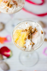 Ice cream dessert on table with hearts, ribbons and cloves.