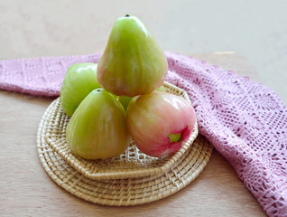 Green rose apple on a basket