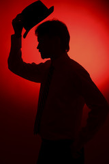 The silhouette of the bride and groom on a red background