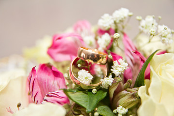 The rings on the flowers, in a box, on a white fabric on toys, colors, wedding details, wedding rings