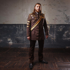 Handsome male Steam punk. Retro man in uniform, portrait over grunge background.