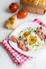 Fried eggs with bacon on white background