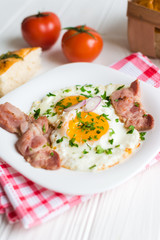 Fried eggs with bacon on white background