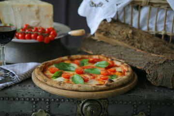 Neapolitan pizza with mozzarella, cherry tomato and fresh basil