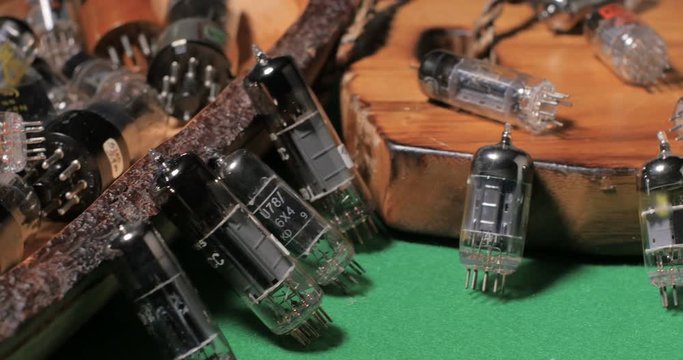 Dolly view of a collection of vintage vacuum tubes (valves) tor music amplifiers manufactured in the forties