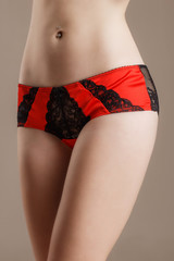 beautiful black red with lace panties closeup on white girl on a beige brown background