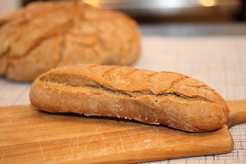 Long french bread on the cutting board.