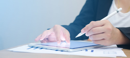 close up businesswoman holding pen for writing drawing on tablet screen electronic devices portable:creativity smart young girl designer drawing sketch something assignment work:light color effect