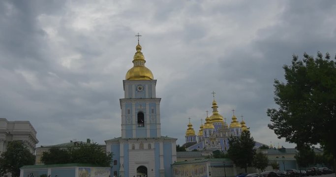 St. Michael's Golden-Domed Monastery With Its High Bell Tower, Beautiful Walls, Panoramic Pictures of Saint People in Grey Weather in Summer
