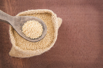 Grains of amaranth on the wooden table (Amaranthus)