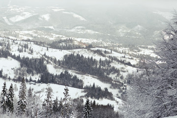 Obraz premium Look from above at dreamy mountains covered with snow