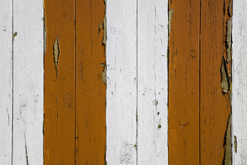 Orange and white painted stripes on wooden boards.
