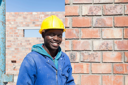 Portrait of builder wearing hard hat looking at camera smiling