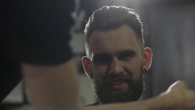 Men's hairstyling and haircutting in a barber shop or hair salon.