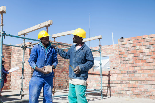Builders talking on building site