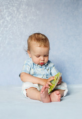 cute baby studying the book sitting