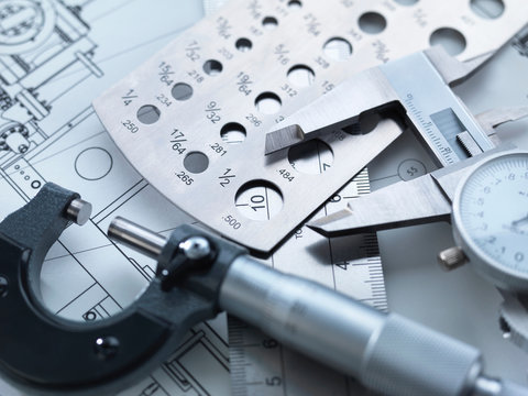Engineering Measurement, Dial calipers sitting on a steel rule with micrometer and engineering drawings