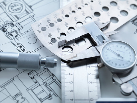 Engineering Measurement, Dial calipers sitting on a steel rule with micrometer and engineering drawings