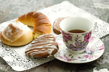 Shot of cup of tea with sweet cookies in color