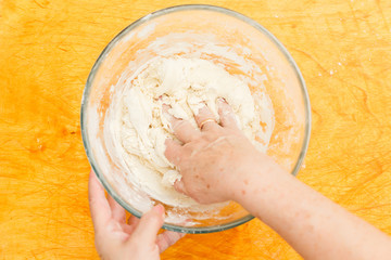 Cook kneads dough in bowl