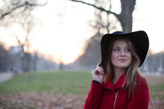 Young woman in floppy hat in park, London, UK