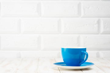 Fototapeta na wymiar Blue cup on the kitchen table