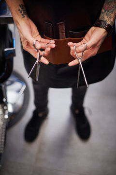 Hairdresser holding scissors