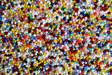 Multicolored glass beads, beading, texture, background.