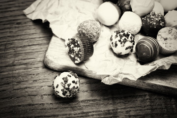 Selection of delicious chocolates on a rustic background