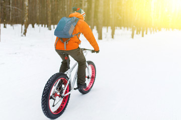 Sportsman on bicycle at winter