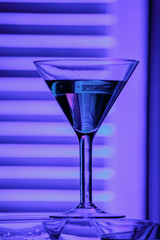 beautiful wine champagne glasse in front of colorful background with shades of blue.