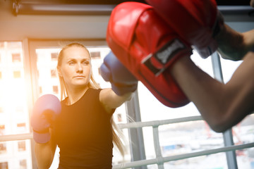 Young sportswoman engaged in boxing