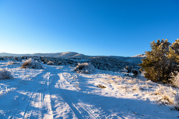 Fototapeta na wymiar Road that leads to snow mountain, winter landscape