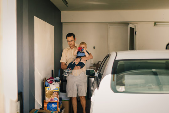 Father holding son in garage