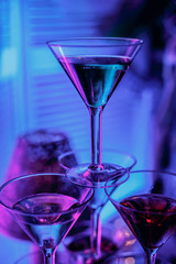 beautiful wine champagne glasse in front of colorful background with shades of blue. © Cheberkus