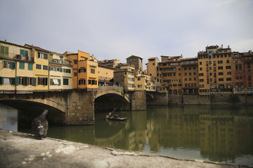 Fototapeta na wymiar The Ponte Vecchio medieval stone closed-spandrel segmental arch bridge over the Arno River, in Florence, Italy, noted for still