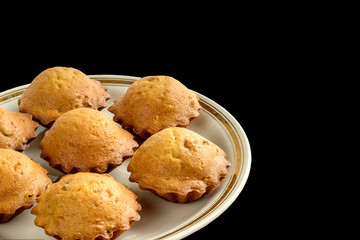 Homemad Tasty muffins on a plate on black background.