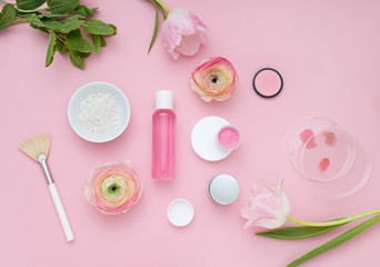 Natural cosmetic pink flat lay with flowers, Top view	