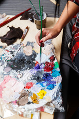 Woman at palette with brush