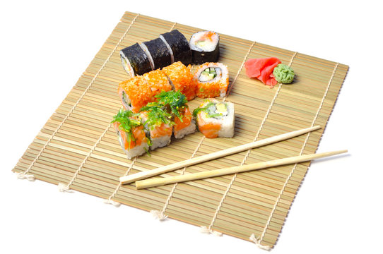 Group of fresh rolled sushi on bamboo sushi mat Stock Photo - Alamy