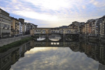 The Ponte Vecchio medieval stone closed-spandrel segmental arch bridge over the Arno River, in...