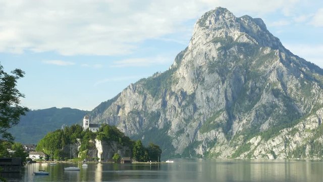Locked down view of Johannesberg Chapel on Traunsee in Traunkirchen, Upper Austria, Austria, with Traunstein in the background.